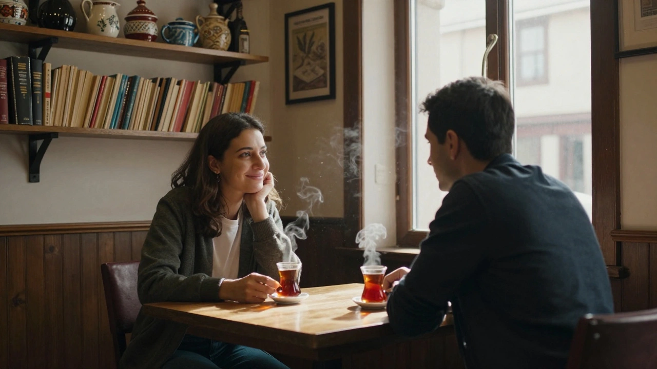 Two people sharing tea in a quiet Çatalca café, warm lamplight and bookshelves in the background.