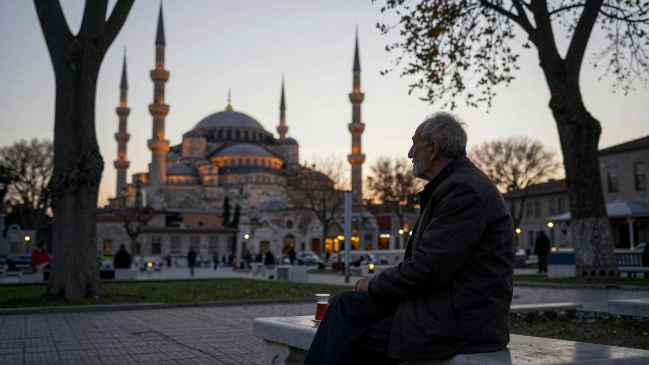 An elderly man sits on a stone bench in Topkapi’s Fourth Courtyard, gazing at the Blue Mosque at dusk.