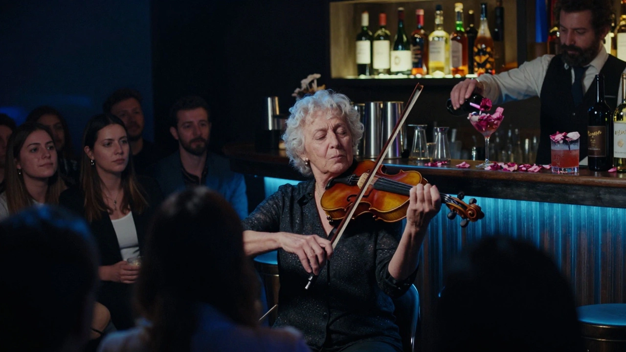 An elderly violinist plays a solo on stage as the crowd sways in silence, bathed in soft blue light at 3 AM.