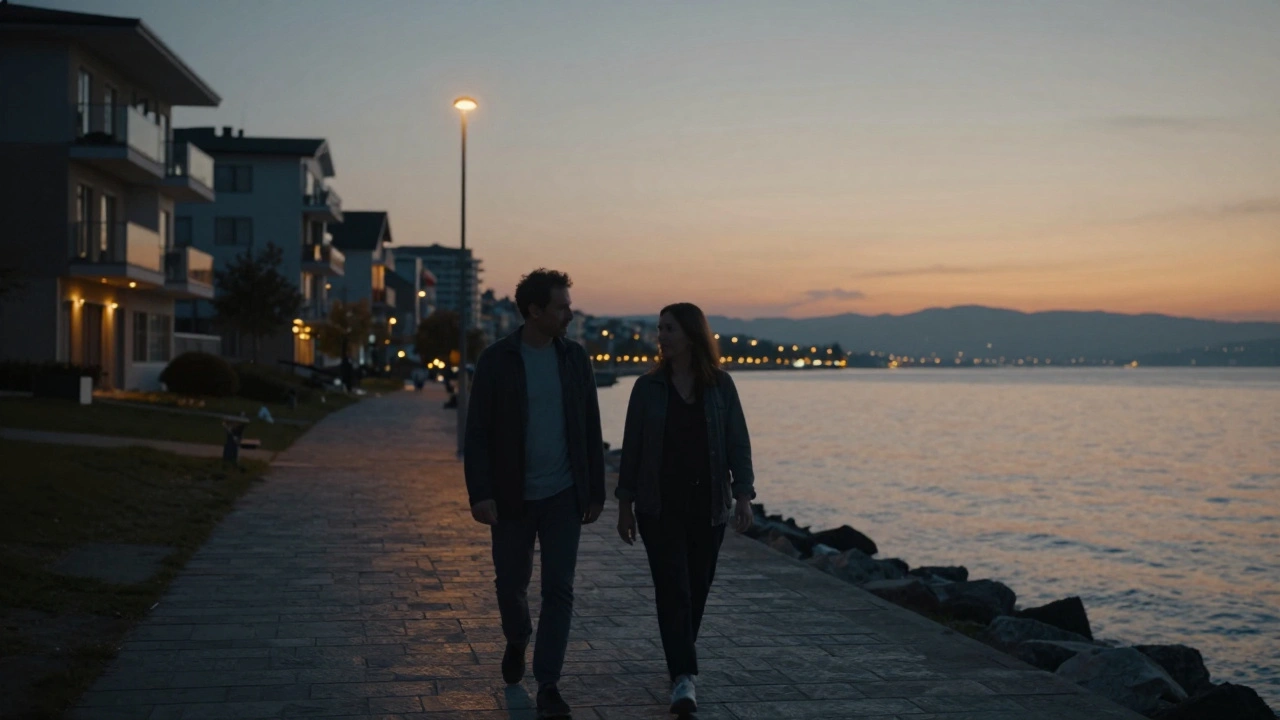 A man and woman walking peacefully along the Kartal waterfront at twilight, overlooking the Bosphorus.