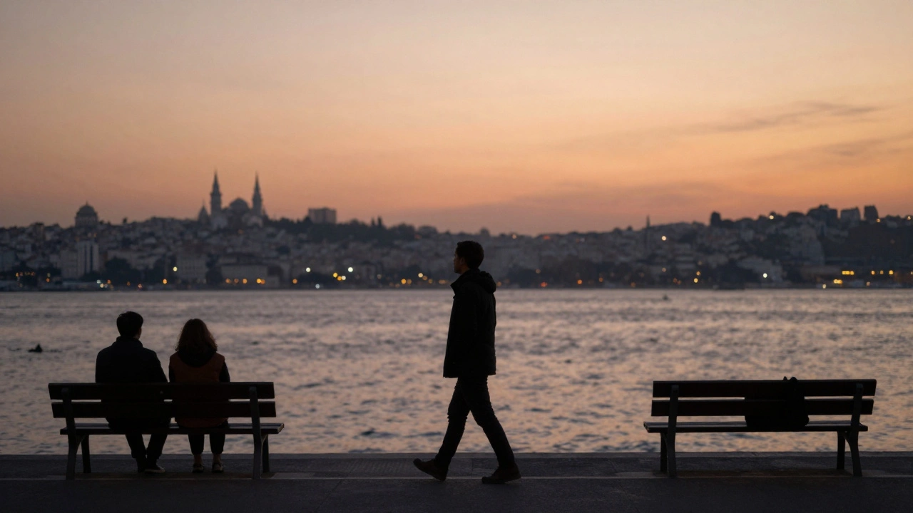 Two distant figures sitting quietly on a Bosphorus bench at sunset, sharing the view.